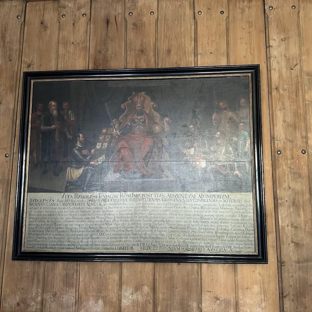 A painting of a king surrounded by people.